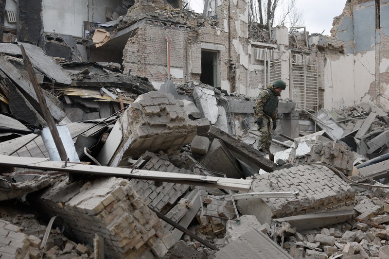 Rescuers work at the site of a building damaged by a Russian missile strike, amid Russia's attack on Ukraine, in Kyiv, Ukraine, March 25, 2024. REUTERS/Valentyn Ogirenko