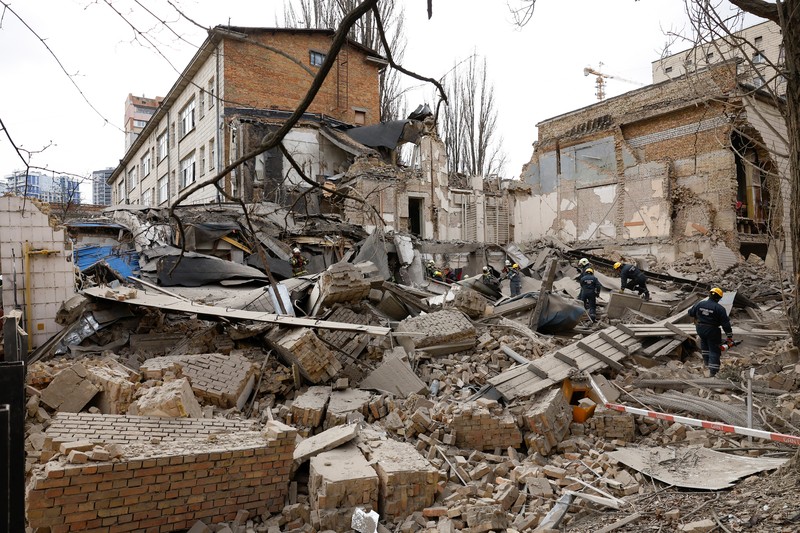 Rescuers work at the site of a building damaged by a Russian missile strike, amid Russia's attack on Ukraine, in Kyiv, Ukraine, March 25, 2024. REUTERS/Valentyn Ogirenko