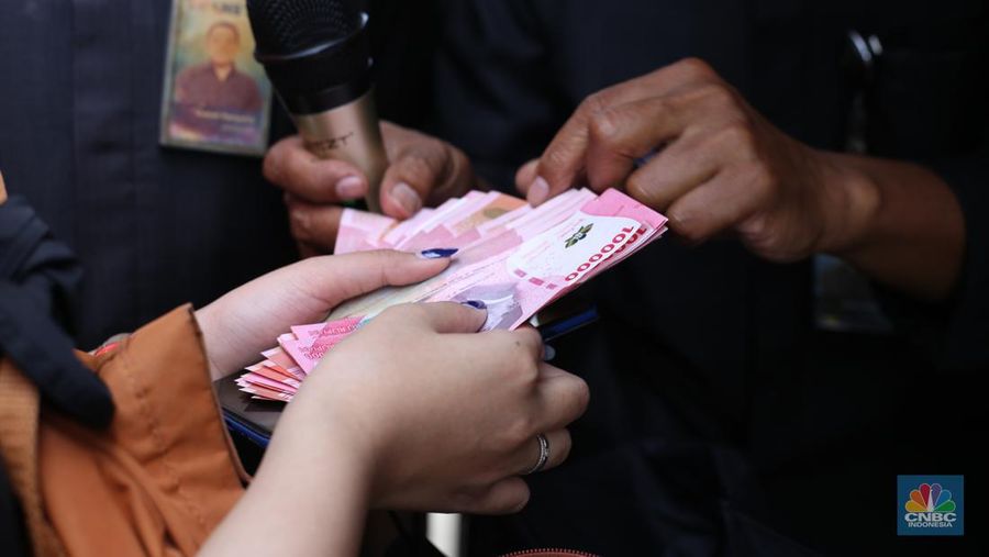 Karyawan Transmedia mengantre untuk menukar uang pecahan di mobil kas keliling Bank Indonesia yang melayani penukaran uang pecahan di Gedung Transmedia, Jakarta, Kamis (28/3/2024). (CNBC Indonesia/Tias Budiarto)
