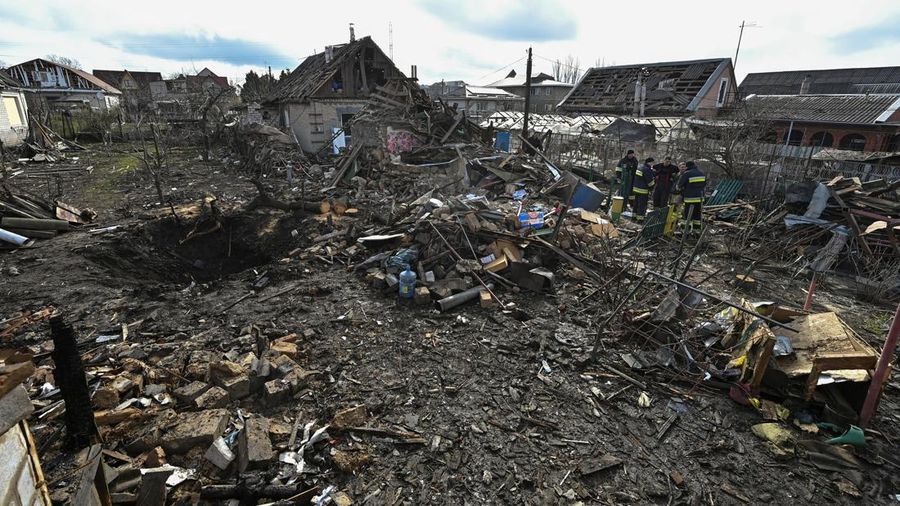 Rescuers work at the site of damaged residential buildings, next to a crater that appeared during a Russian drone strike, amid Russia's attack on Ukraine, in Zaporizhzhia, Ukraine March 28, 2024. REUTERS/Stringer