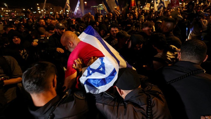 Puluhan ribu orang melakukan aksi unjuk rasa di depan gedung parlemen Israel di Yerusalem pada MInggu (31/3), menuntut Perdana Menteri Benjamin Netanyahu mundur dan pemilihan umum dini. (REUTERS/Ilan Rosenberg)