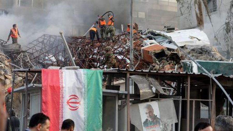 Emergency and security personnel extinguish a fire at the site of strikes which hit a building annexed to the Iranian embassy in Syria's capital Damascus, on April 1, 2024. Syrian state media said Israeli strikes hit an Iranian consular annex in the capital on April 1, while a war monitor reported eight people were killed and Iranian state media said a senior commander of the powerful Islamic Revolutionary Guard Corps was among the dead, amid rising regional tensions due to the Gaza war. (Photo by LOUAI BESHARA / AFP)