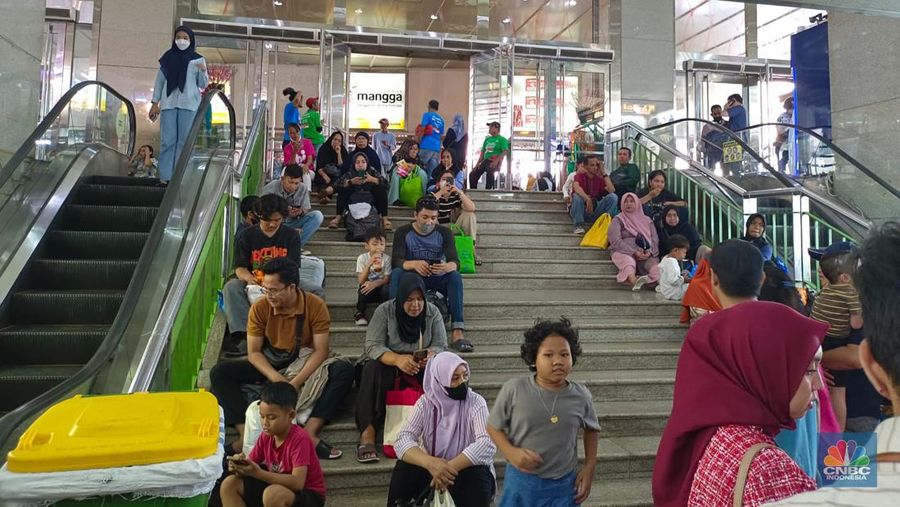Penampakan pengunjung Tanah Abang kelelahan sampai ngemper di tangga. (CNBC Indonesia/Martyasari Rizky)