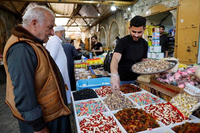 Palestinians prepare for Eid al-Fitr, amid the ongoing conflict between Israel and the Palestinian Islamist group Hamas, in Nablus, in the Israeli-occupied West Bank, April 6, 2024. REUTERS/Raneen Sawafta