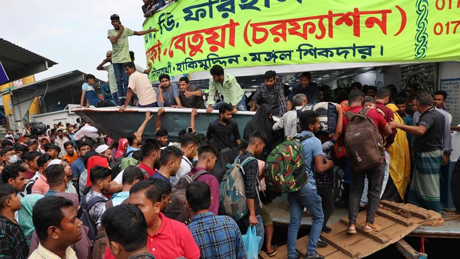 People get into a ferry at the Sadarghat Ferry Terminal to go home to celebrate Eid al-Fitr with their family, in Dhaka, Bangladesh, April 8, 2024. REUTERS/Mohammad Ponir Hossain