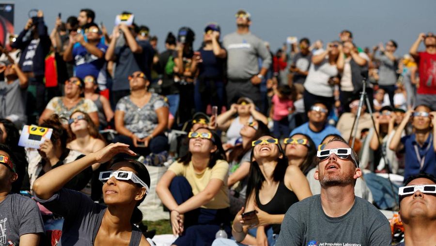 FILE PHOTO: People watch the solar eclipse on the lawn of Griffith Observatory in Los Angeles, California, U.S., August 21, 2017. REUTERS/Mario Anzuoni/File Photo