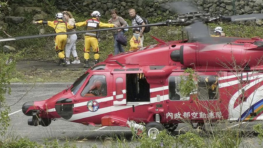 Heavy equipment begins demolition of a collapsed building, two days after a powerful earthquake struck the city, in Hualien City, eastern Taiwan, Friday, April 5, 2024. (AP Photo/Chiang Ying-ying)