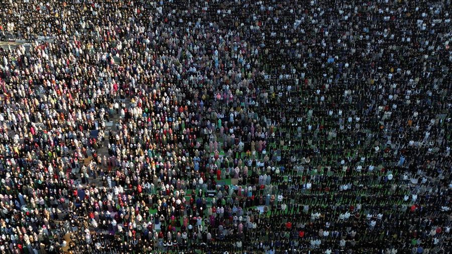 Muslim Albania yang menghadiri salat Idul Fitri untuk menandai akhir bulan suci Ramadhan, di Lapangan Skanderbeg di Tirana, Albania. (REUTERS/Florion Goga)