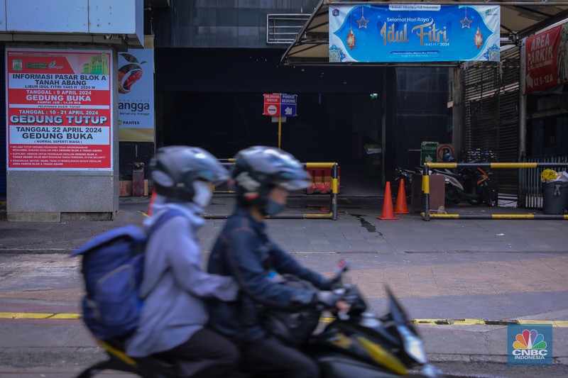 Pengendara sepeda motor melintas di depan Blok A Pasar Tanah Abang yang tutup di Jakarta, Jumat (12/4/2024). (CNBC Indonesia/Faisal Rahman)