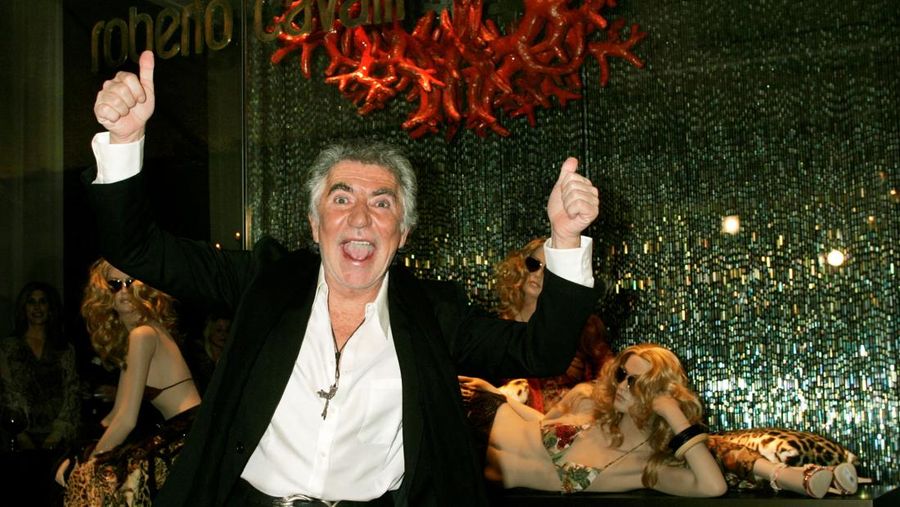 FILE PHOTO: Italian fashion designer Roberto Cavalli poses in front of a window displaying his designs at the opening of the Roberto Cavalli Boutique in Beverly Hills, February 15, 2005. REUTERS/Fred Prouser  FSP/LD/File Photo