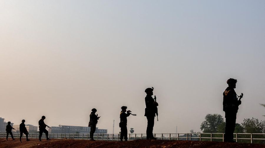 Military personnel stand guard as hundreds of refugees crossed over the river frontier between Myanmar and Thailand on Friday following the fall of a strategic border town to rebels fighting Myanmar's military junta, in Mae Sot, Tak province, Thailand, April 13, 2024. REUTERS/Athit Perawongmetha