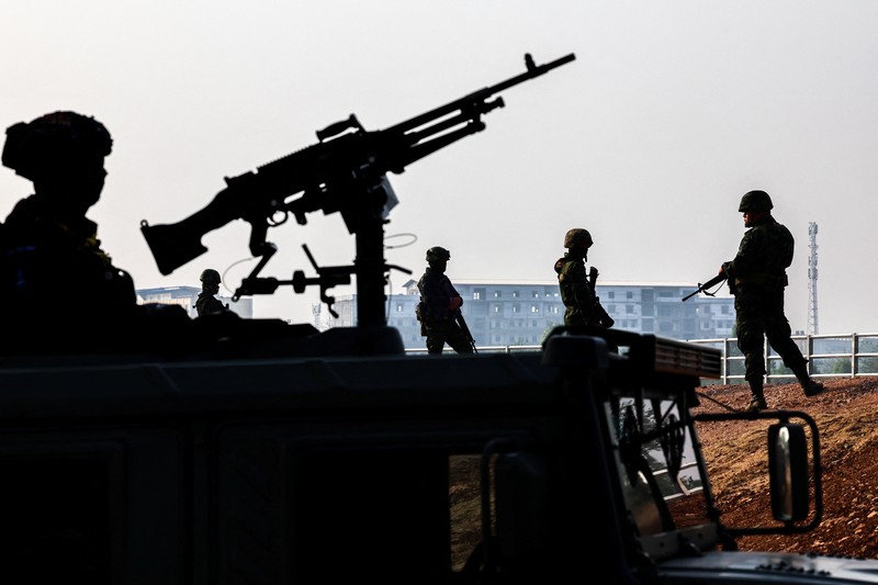 Military personnel stand guard as hundreds of refugees crossed over the river frontier between Myanmar and Thailand on Friday following the fall of a strategic border town to rebels fighting Myanmar's military junta, in Mae Sot, Tak province, Thailand, April 13, 2024. REUTERS/Athit Perawongmetha