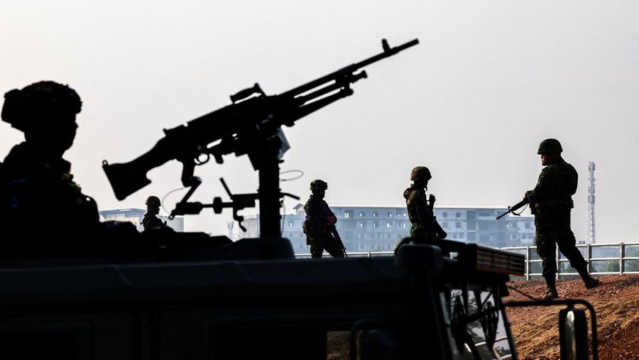 Military personnel stand guard as hundreds of refugees crossed over the river frontier between Myanmar and Thailand on Friday following the fall of a strategic border town to rebels fighting Myanmar's military junta, in Mae Sot, Tak province, Thailand, April 13, 2024. REUTERS/Athit Perawongmetha