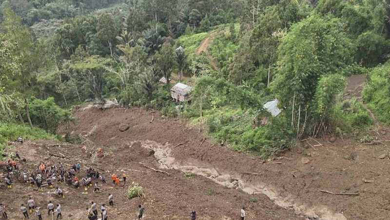 Gambar udara yang diambil dan dirilis pada 15 April 2024 oleh Badan Pencarian dan Pertolongan Nasional (BASARNAS) menunjukkan tim penyelamat mencari orang hilang di lokasi tanah longsor yang menewaskan sedikitnya 18 orang dan menyebabkan dua orang hilang di Tana Toraja, Selatan Sulawesi. (Photo by Handout / National Search and Rescue Agency (BASARNAS) / AFP)