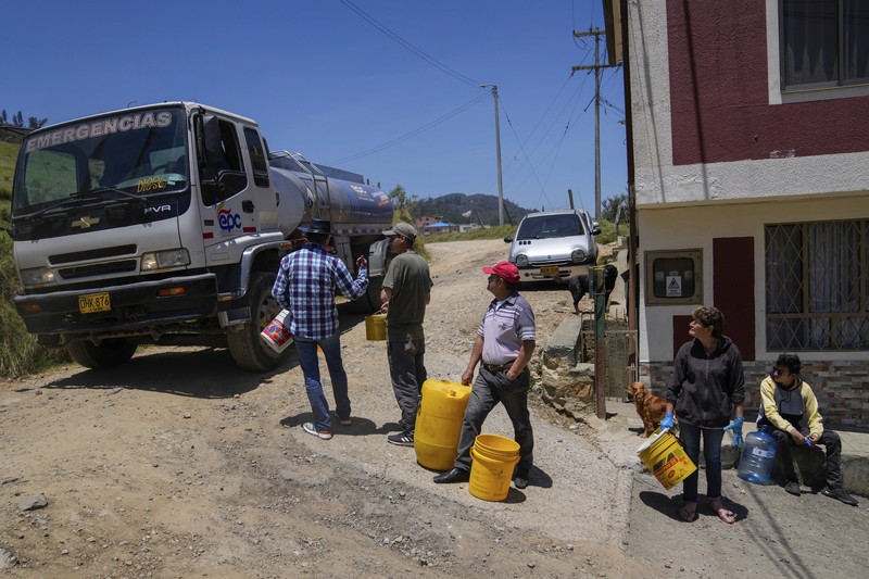 Warga mengantri untuk mengambil air dari truk saat penjatahan air di La Calera, pinggiran Bogota, Kolombia, Selasa, 16 April 2024. Di tengah kekeringan terkait pola cuaca El Niño, beberapa wilayah di Kolombia mengambil tindakan untuk mengambil air dari truk. membatasi konsumsi air ketika jumlah waduk terbatas. (AP Photo/Fernando Vergara)