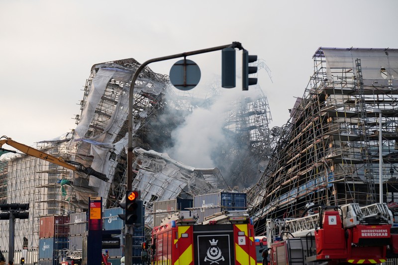 A smoke rises from the ruins of the Old Stock Exchange building Boersen, after the outer walls collapsed in a fire, in Copenhagen, Denmark April 19, 2024. Ritzau Scanpix/Emil Helms via REUTERS    ATTENTION EDITORS - THIS IMAGE WAS PROVIDED BY A THIRD PARTY. DENMARK OUT. NO COMMERCIAL OR EDITORIAL SALES IN DENMARK.