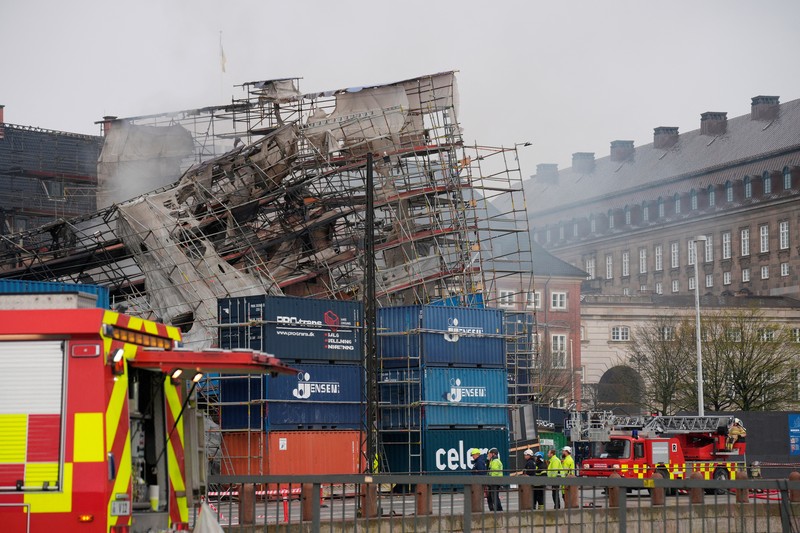 A smoke rises from the ruins of the Old Stock Exchange building Boersen, after the outer walls collapsed in a fire, in Copenhagen, Denmark April 19, 2024. Ritzau Scanpix/Emil Helms via REUTERS    ATTENTION EDITORS - THIS IMAGE WAS PROVIDED BY A THIRD PARTY. DENMARK OUT. NO COMMERCIAL OR EDITORIAL SALES IN DENMARK.