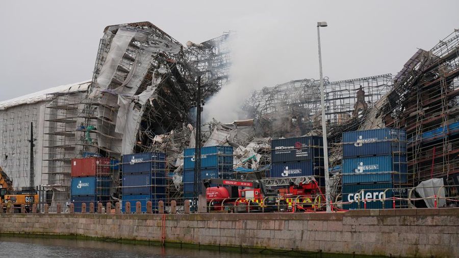A smoke rises from the ruins of the Old Stock Exchange building Boersen, after the outer walls collapsed in a fire, in Copenhagen, Denmark April 19, 2024. Ritzau Scanpix/Emil Helms via REUTERS    ATTENTION EDITORS - THIS IMAGE WAS PROVIDED BY A THIRD PARTY. DENMARK OUT. NO COMMERCIAL OR EDITORIAL SALES IN DENMARK.
