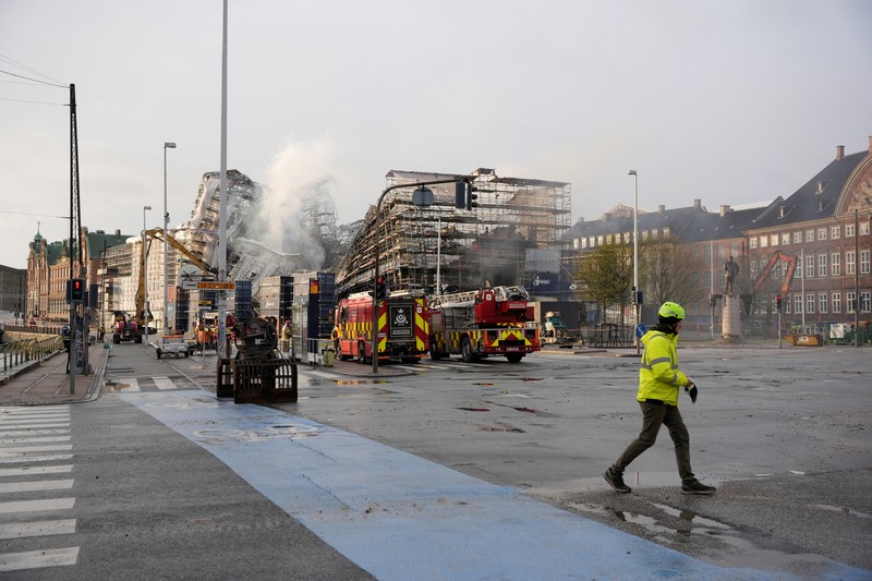 A smoke rises from the ruins of the Old Stock Exchange building Boersen, after the outer walls collapsed in a fire, in Copenhagen, Denmark April 19, 2024. Ritzau Scanpix/Emil Helms via REUTERS    ATTENTION EDITORS - THIS IMAGE WAS PROVIDED BY A THIRD PARTY. DENMARK OUT. NO COMMERCIAL OR EDITORIAL SALES IN DENMARK.