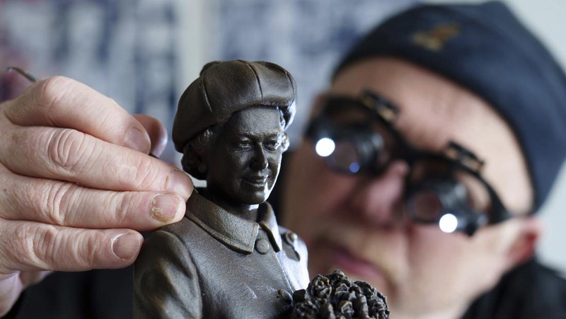 Pematung Staffordshire Andy Edwards berpose sambil menyempurnakan studi potret dengan lilin untuk patung Ratu Elizabeth II yang ditugaskan oleh Dewan Borough Newcastle-under-Lyme untuk menandai ulang tahun ke-850 wilayah tersebut, Newcastle-Under-Lyme, Inggris, Kamis, 18 April 2024. Edwards yang karya sebelumnya termasuk patung terkenal Beatles di Pier Head Liverpool, mendasarkan patung tersebut pada foto kunjungan mendiang Ratu ke Newcastle-under-Lyme sebagai bagian dari perayaan ulang tahun ke-800 Borough pada tahun 1973. (AP Photo/Jon Super)