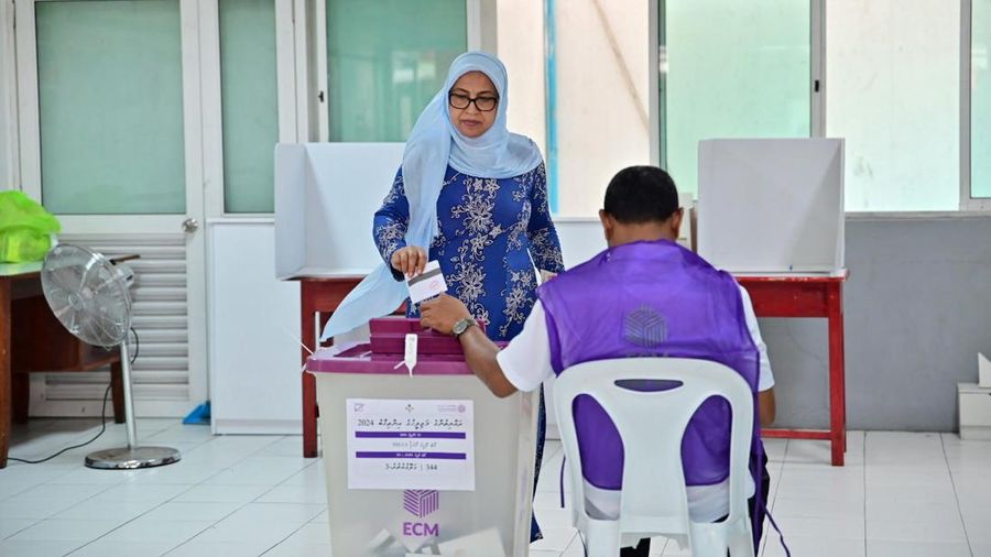A woman casts her vote at a polling station in Male, India, Sunday, April 21, 2024. Maldivians are voting in parliamentary elections, in a ballot crucial for President Mohamed Muizzu, whose policies are keenly watched by India and China as they vie for influence in the archipelago nation. (AP Photo/Mohamed Sharuhaan)