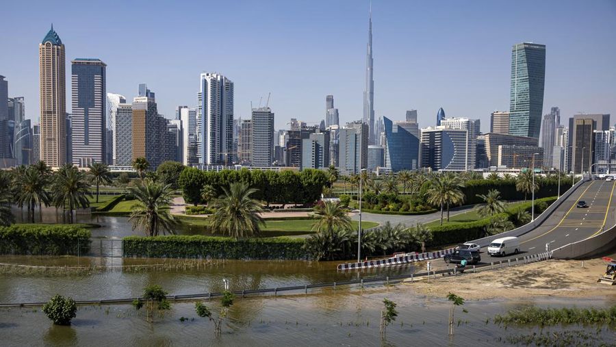 An abandoned vehicle stands in floodwater caused by heavy rain with the Burj Khalifa, the world's tallest building, seen on the background, in Dubai, United Arab Emirates, Thursday, April 18, 2024. The United Arab Emirates attempted to dry out Thursday from the heaviest rain the desert nation has ever recorded, a deluge that flooded out Dubai International Airport and disrupted flights through the world's busiest airfield for international travel. (AP Photo/Christopher Pike)