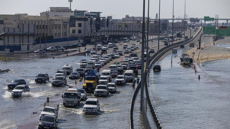 Residents canoe through the Mudon neighborhood in Dubai, United Arab Emirates, Thursday, April 18, 2024. The United Arab Emirates attempted to dry out Thursday from the heaviest rain the desert nation has ever recorded — a deluge that flooded out Dubai International Airport and disrupted flights through the world's busiest airfield for international travel. (AP Photo/Jon Gambrell)
