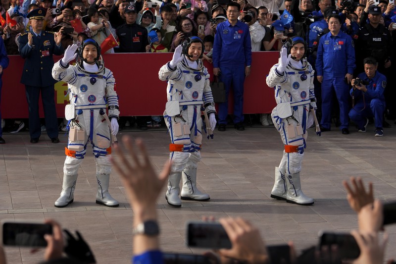 Astronot Tiongkok untuk misi Shenzhou-18, dari kanan, Ye Guangfu, Li Cong, dan Li Guangsu melambai saat mereka menghadiri upacara pelepasan misi luar angkasa berawak mereka di Pusat Peluncuran Satelit Jiuquan di barat laut Tiongkok, Kamis, 25 April. 2024. (AP/Andy Wong)