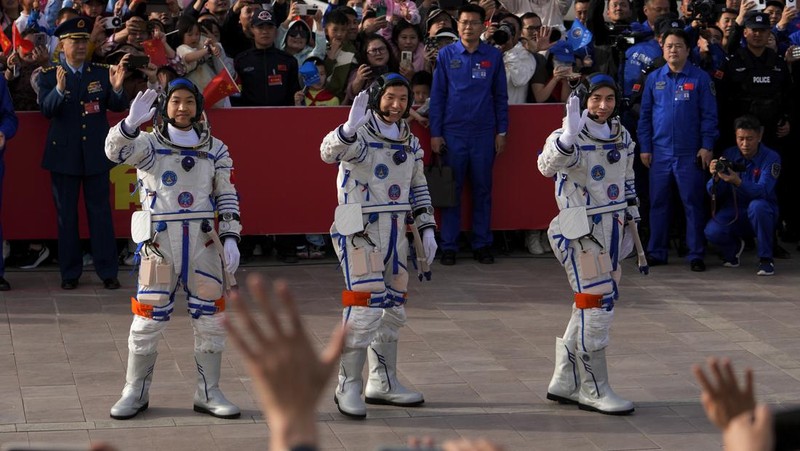 Astronot Tiongkok untuk misi Shenzhou-18, dari kanan, Ye Guangfu, Li Cong, dan Li Guangsu melambai saat mereka menghadiri upacara pelepasan misi luar angkasa berawak mereka di Pusat Peluncuran Satelit Jiuquan di barat laut Tiongkok, Kamis, 25 April. 2024. (AP/Andy Wong)