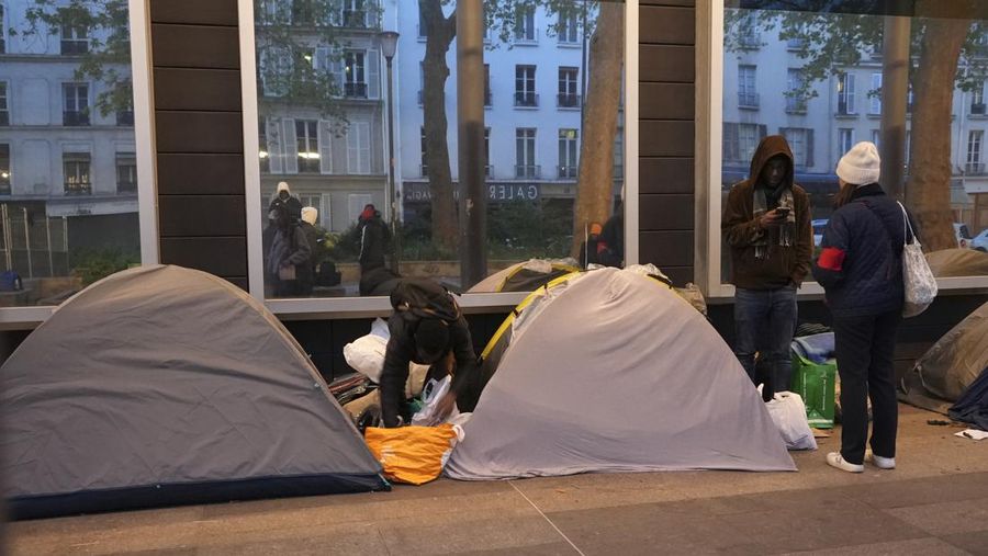 Seorang migran mengemas barang-barangnya di kamp darurat, Selasa dini hari, 23 April 2024 di Paris. Petugas polisi Prancis telah mengusir para migran dari kamp darurat di Paris yang berjarak beberapa langkah dari Sungai Seine, karena operasi serupa telah dilakukan oleh pihak berwenang menjelang Olimpiade. (AP Photo/Nicolas Garriga)
