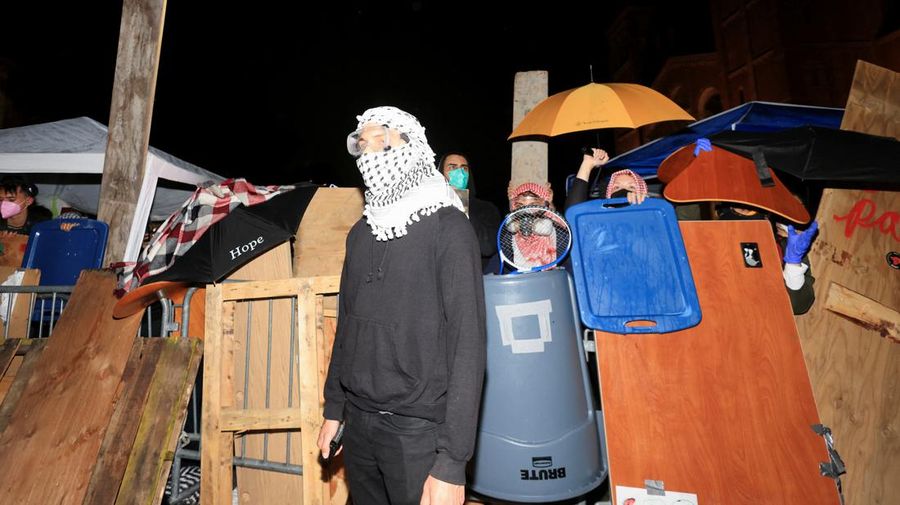A person stands as counter-protesters clash with protesters in support of Palestinians in Gaza at an encampment on the campus of the University of California, Los Angeles (UCLA), amid the ongoing conflict between Israel and the Palestinian Islamist group Hamas, in Los Angeles, California, U.S., May 1, 2024. REUTERS/David Swanson