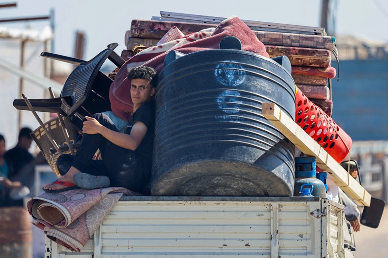 Palestinians travel in a vehicle as they flee Rafah after Israeli forces launched a ground and air operation in the eastern part of the southern Gaza city, amid the ongoing conflict between Israel and Hamas, in the southern Gaza Strip May 9, 2024. REUTERS/Mohammed Salem