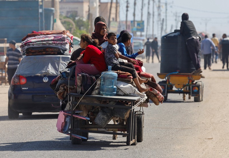 Palestinians travel in a vehicle as they flee Rafah after Israeli forces launched a ground and air operation in the eastern part of the southern Gaza city, amid the ongoing conflict between Israel and Hamas, in the southern Gaza Strip May 9, 2024. REUTERS/Mohammed Salem