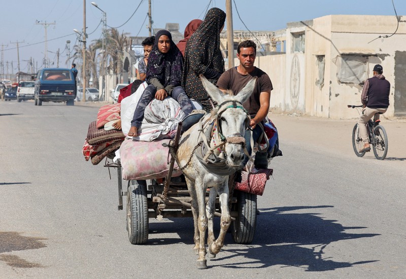 Palestinians travel in a vehicle as they flee Rafah after Israeli forces launched a ground and air operation in the eastern part of the southern Gaza city, amid the ongoing conflict between Israel and Hamas, in the southern Gaza Strip May 9, 2024. REUTERS/Mohammed Salem
