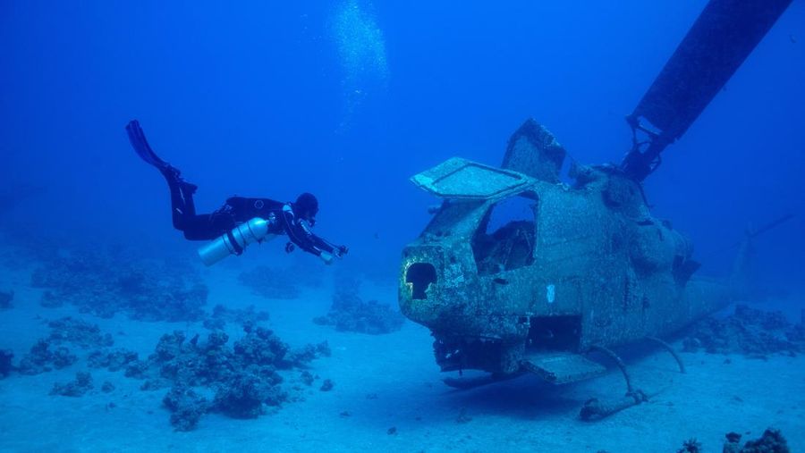 Seorang penyelam berenang di samping kendaraan militer yang tenggelam di Museum Militer Bawah Air di Aqaba, Yordania, 7 Mei 2024. (REUTERS/Stelios Misinas)     TPX IMAGES OF THE DAY