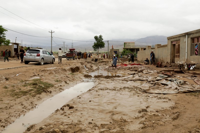 AFGHANISTAN-WEATHER-FLOOD Afghan relatives offer prayers during a burial ceremony, near the graves of victim who lost their lives following flash floods after heavy rainfall at a village in Baghlan-e-Markazi district of Baghlan province on May 11, 2024. More than 300 people were killed in flash flooding in Afghanistan's northern province of Baghlan, the World Food Programme said on May 11. (Photo by Atif Aryan / AFP)