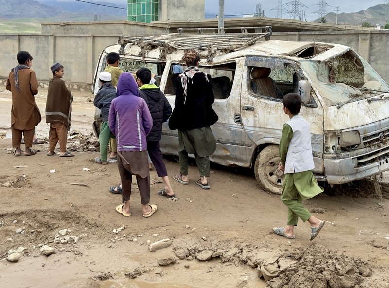 Afghan relatives offer prayers during a burial ceremony, near the graves of victim who lost their lives following flash floods after heavy rainfall at a village in Baghlan-e-Markazi district of Baghlan province on May 11, 2024. More than 300 people were killed in flash flooding in Afghanistan's northern province of Baghlan, the World Food Programme said on May 11. (Photo by Atif Aryan / AFP)
