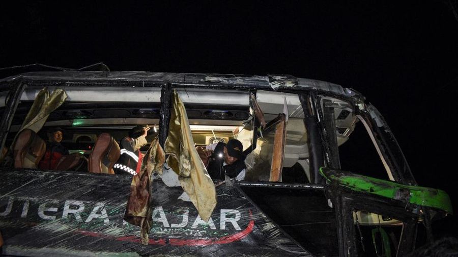 Officers check the inside of a bus after a crash that killed 11 people, according to local police, in Subang, West Java, on May 11, 2024. (Photo by Timur MATAHARI / AFP)