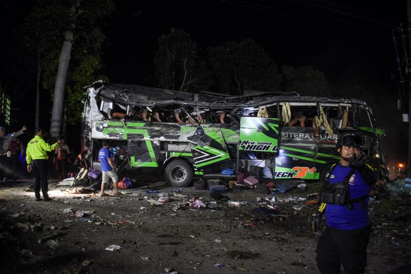 INDONESIA-ACCIDENT-BUS Officers check the debris and belongings of passengers after a bus crash that killed 11 people, according to local police, in Subang, West Java, on May 11, 2024. (Photo by Timur MATAHARI / AFP)