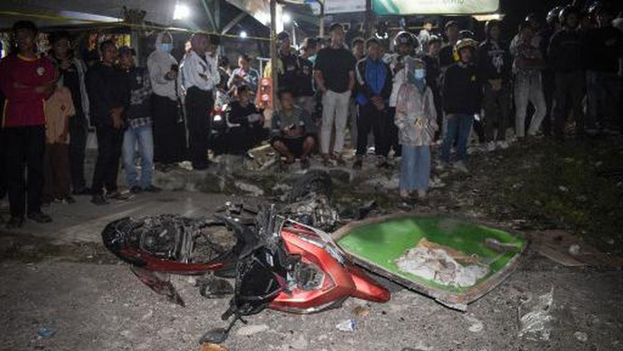 Officers check the debris and belongings of passengers after a bus crash that killed 11 people, according to local police, in Subang, West Java, on May 11, 2024. (Photo by Timur MATAHARI / AFP)
