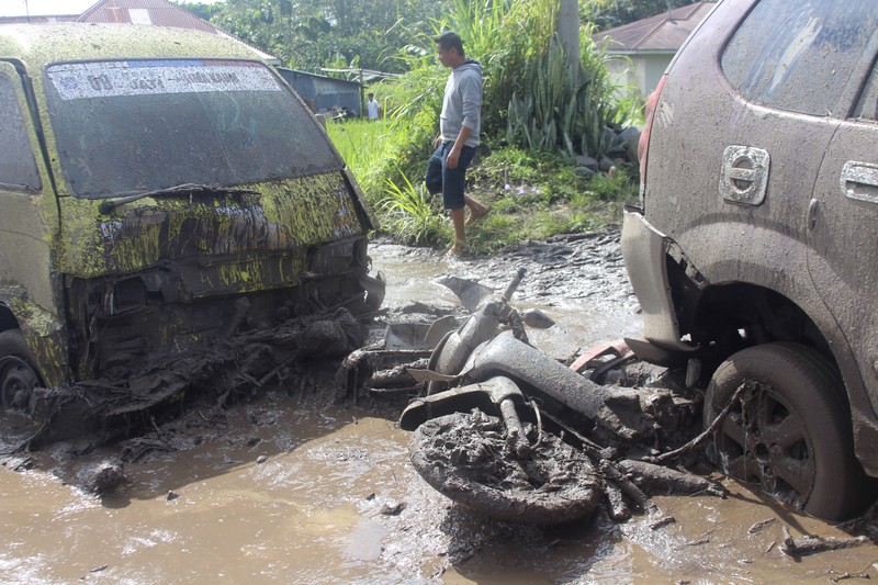 Indonesia Flash Floods People inspect an area affected by flash flood in Agam, West Sumatra, Indonesia, Sunday, May 12, 2024. Heavy rains and torrents of cold lava and mud rushing down a volcano on Indonesia’s Sumatra island have triggered flash floods that killed more than a dozen of people and injured several others, officials said Sunday. (AP Photo/Ali Nayaka)
