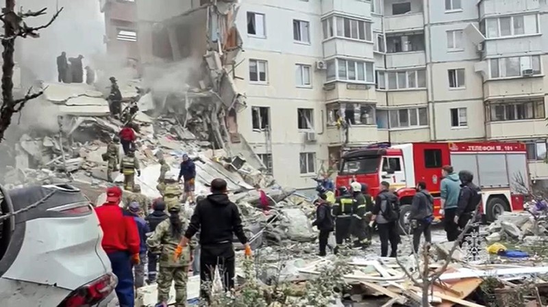 In this photo taken from video released by the Russian Emergency Ministry Press Service on Sunday, May 12, 2024, Russian emergency services work at the scene of a partially collapsed block of flats authorities said was hit during an attack by Ukrainian shelling, in Belgorod, Russia. (Russian Emergency Ministry Press Service via AP)