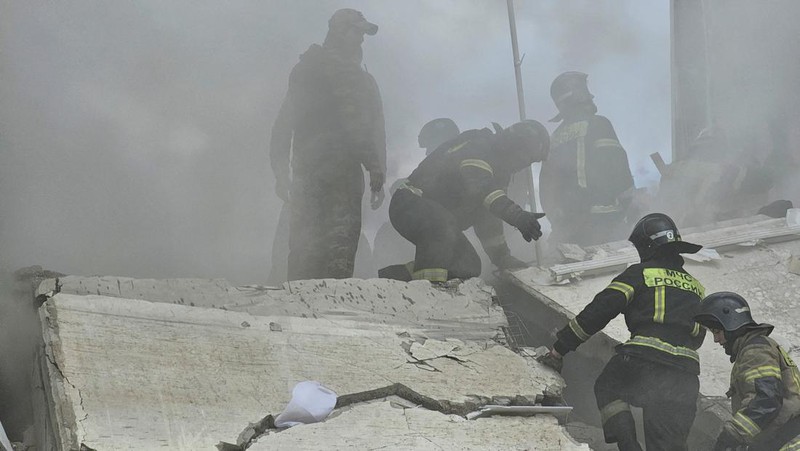 In this photo taken from video released by the Russian Emergency Ministry Press Service on Sunday, May 12, 2024, Russian emergency services work at the scene of a partially collapsed block of flats authorities said was hit during an attack by Ukrainian shelling, in Belgorod, Russia. (Russian Emergency Ministry Press Service via AP)