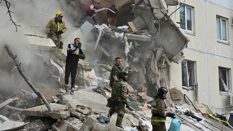In this photo taken from video released by the Russian Emergency Ministry Press Service on Sunday, May 12, 2024, Russian emergency services work at the scene of a partially collapsed block of flats authorities said was hit during an attack by Ukrainian shelling, in Belgorod, Russia. (Russian Emergency Ministry Press Service via AP)