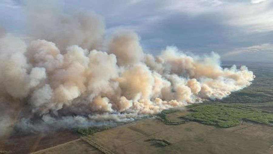 This aerial handout picture courtesy of the Alberta Wildfire Service, taken May 10, 2024, shows smoke from wildfires burning in the Grande prairie forest area, 4 kilometers east of the town of Teepee Creek, in Alberta, Canada. Thousands of people fled their homes on May 12, 2024 in western Canada as hundreds of wildfires beginning earlier than usual portend a difficult fire season. (Photo by Handout / Alberta Wildfire Service / AFP) / RESTRICTED TO EDITORIAL USE - MANDATORY CREDIT 