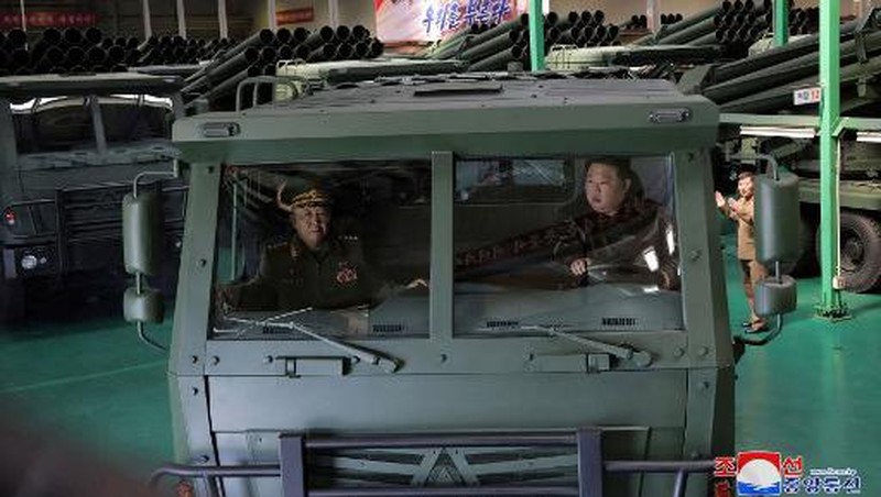 This recent undated picture released by North Korea's official Korean Central News Agency (KCNA) via KNS on May 13, 2024 shows North Korea's leader Kim Jong Un (C) inspecting carriers with a 240mm multiple rocket launcher system while visiting a national defence industrial enterprise at an undisclosed location in North Korea. (Photo by KCNA VIA KNS / AFP) / South Korea OUT / REPUBLIC OF KOREA OUT
---EDITORS NOTE--- RESTRICTED TO EDITORIAL USE - MANDATORY CREDIT 