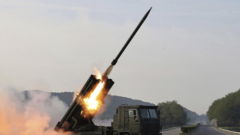 This recent undated picture released by North Korea's official Korean Central News Agency (KCNA) via KNS on May 13, 2024 shows North Korea's leader Kim Jong Un (C) inspecting carriers with a 240mm multiple rocket launcher system while visiting a national defence industrial enterprise at an undisclosed location in North Korea. (Photo by KCNA VIA KNS / AFP) / South Korea OUT / REPUBLIC OF KOREA OUT
---EDITORS NOTE--- RESTRICTED TO EDITORIAL USE - MANDATORY CREDIT 
