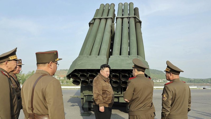 This recent undated picture released by North Korea's official Korean Central News Agency (KCNA) via KNS on May 13, 2024 shows North Korea's leader Kim Jong Un (C) inspecting carriers with a 240mm multiple rocket launcher system while visiting a national defence industrial enterprise at an undisclosed location in North Korea. (Photo by KCNA VIA KNS / AFP) / South Korea OUT / REPUBLIC OF KOREA OUT
---EDITORS NOTE--- RESTRICTED TO EDITORIAL USE - MANDATORY CREDIT 