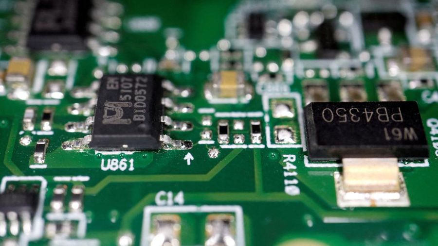 FILE PHOTO: Semiconductor chips are seen on a printed circuit board in this illustration picture taken February 17, 2023. REUTERS/Florence Lo/Illustration/File Photo