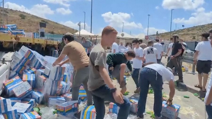 Sejumlah warga Israel memblokir truk bantuan yang menuju Gaza dan merusak serta menginjak paket makanan yang dibawa pada Senin (13/5/2024). Dari kemasannya, terlihat bahwa paket makanan tersebut termasuk produk seperti Indomie yang dikirim ke Gaza. (Tangkapan Layar Video Reuters/KAN2COME)